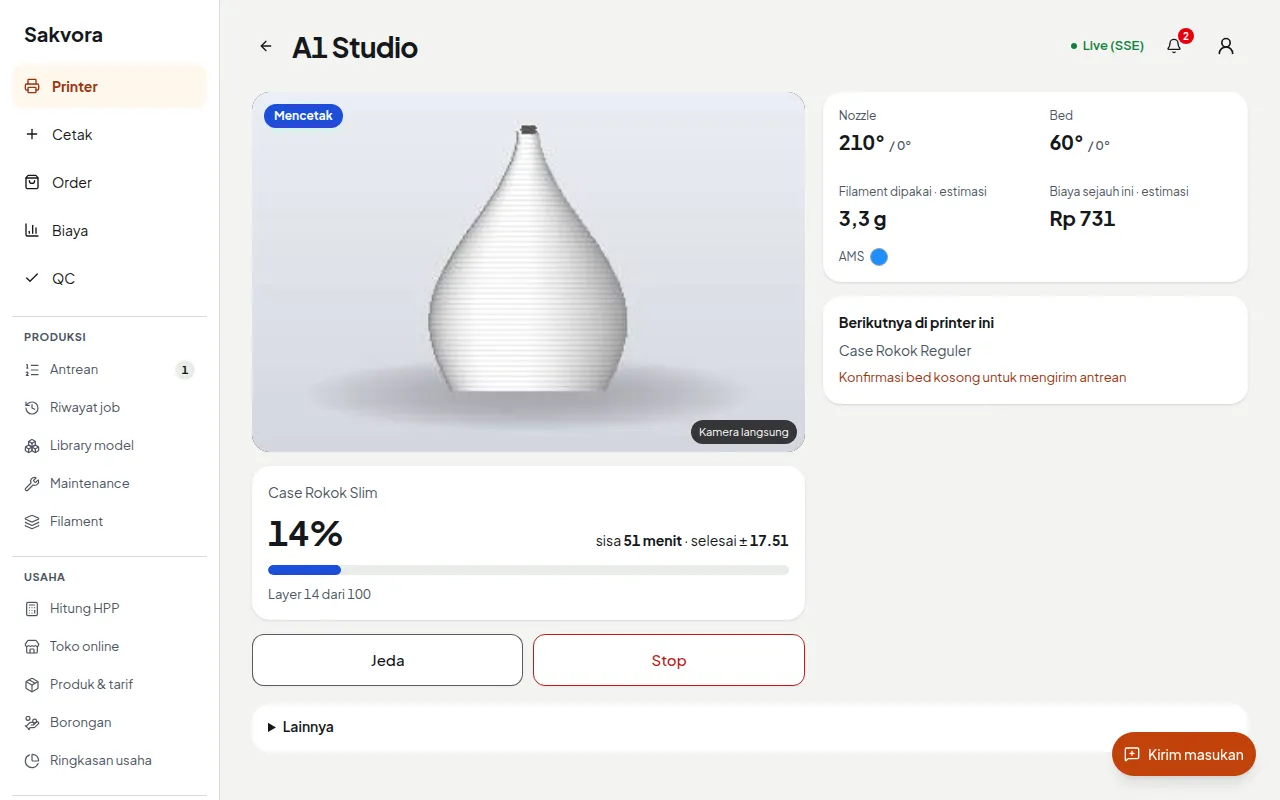 A1 printer page while printing: live camera, progress, time remaining, temperature, filament, and cost so far